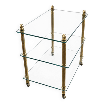 Elegant wheeled serving trolley in gilded brass and glass, in a stylish spirit.