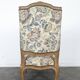 Louis XV style armchair in natural wood with floral fabric.