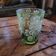 Green gradient blown glass vase with engraved floral decoration.