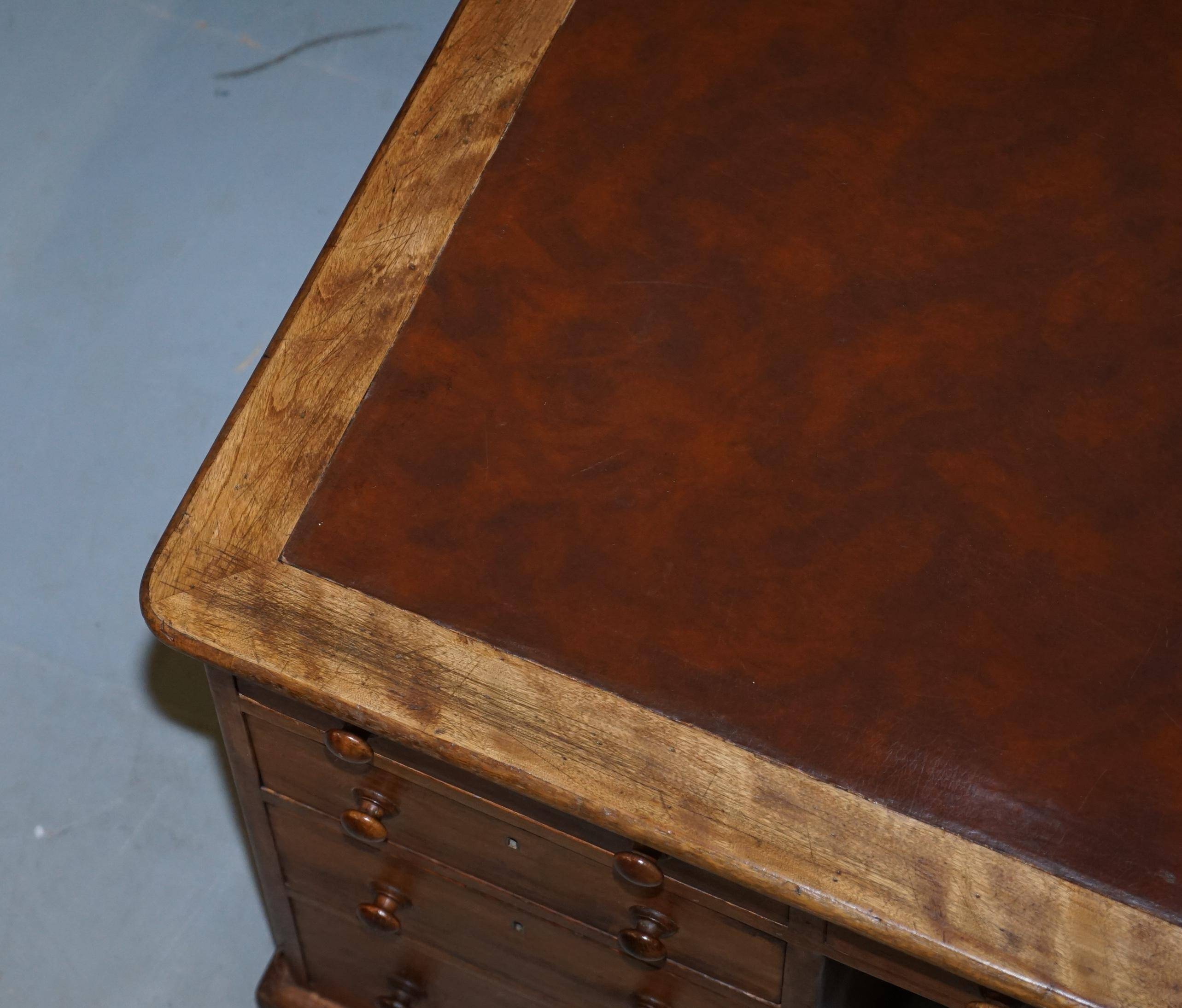 Antique Victorian oak kneehole desk with 18 double-sided drawers.