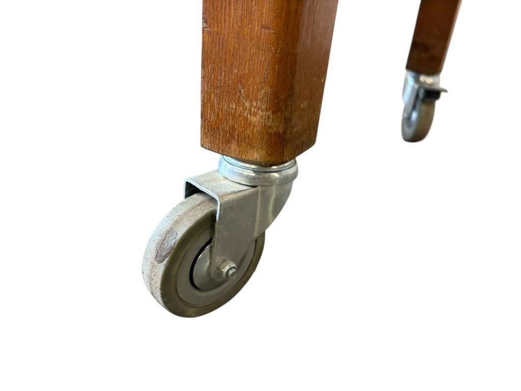 Vintage wooden high table on wheels