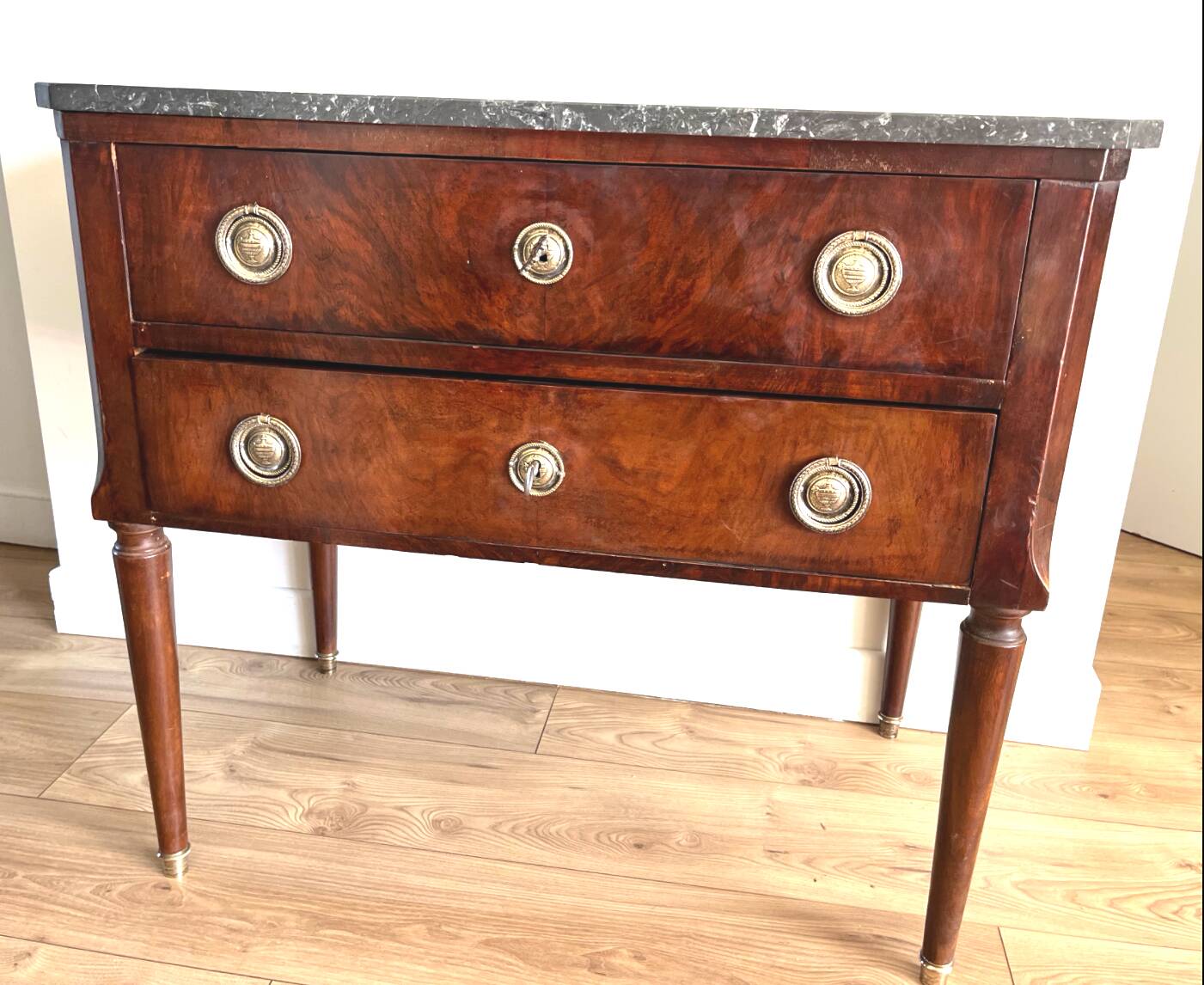 Louis XVI style wooden veneered chest of drawers with a marble top.