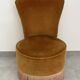 Ochre and fringed pouffe-style armchair