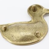 Empty brass duck bag