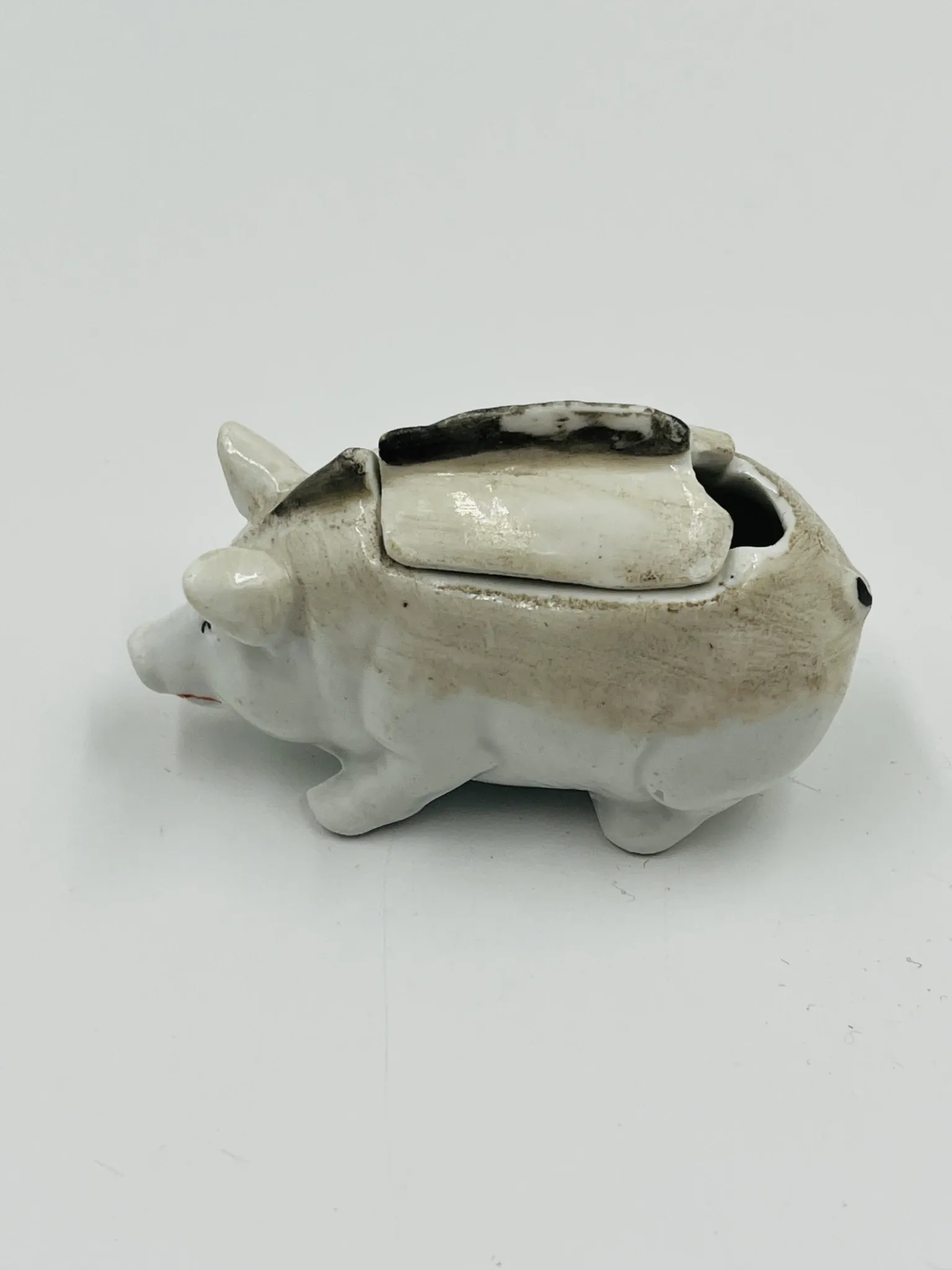 Vintage mustard pot in porcelain shaped like a pig.