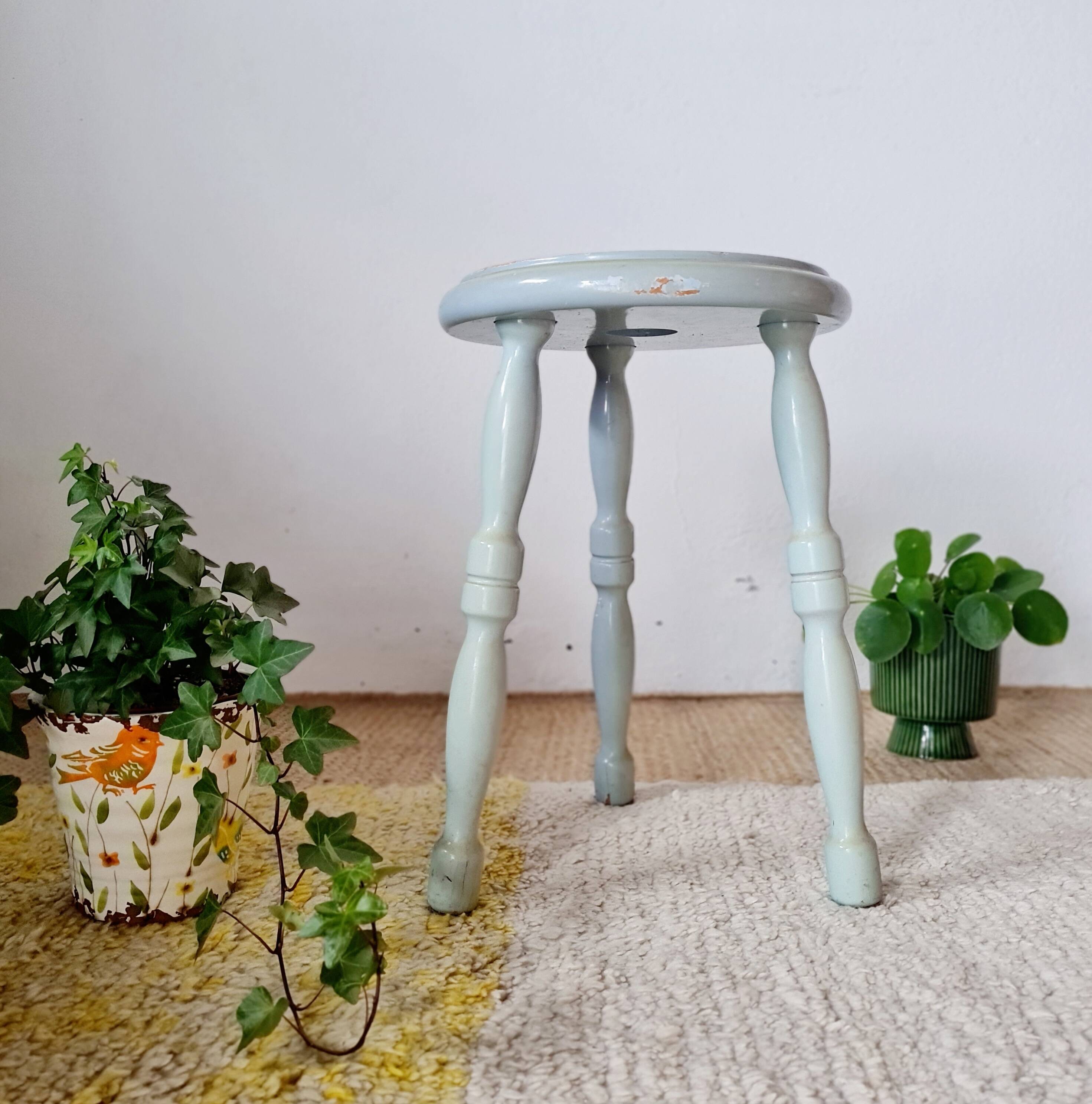 Antique tripod stool made of solid wood in blue.