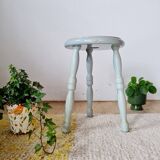 Antique tripod stool made of solid wood in blue.