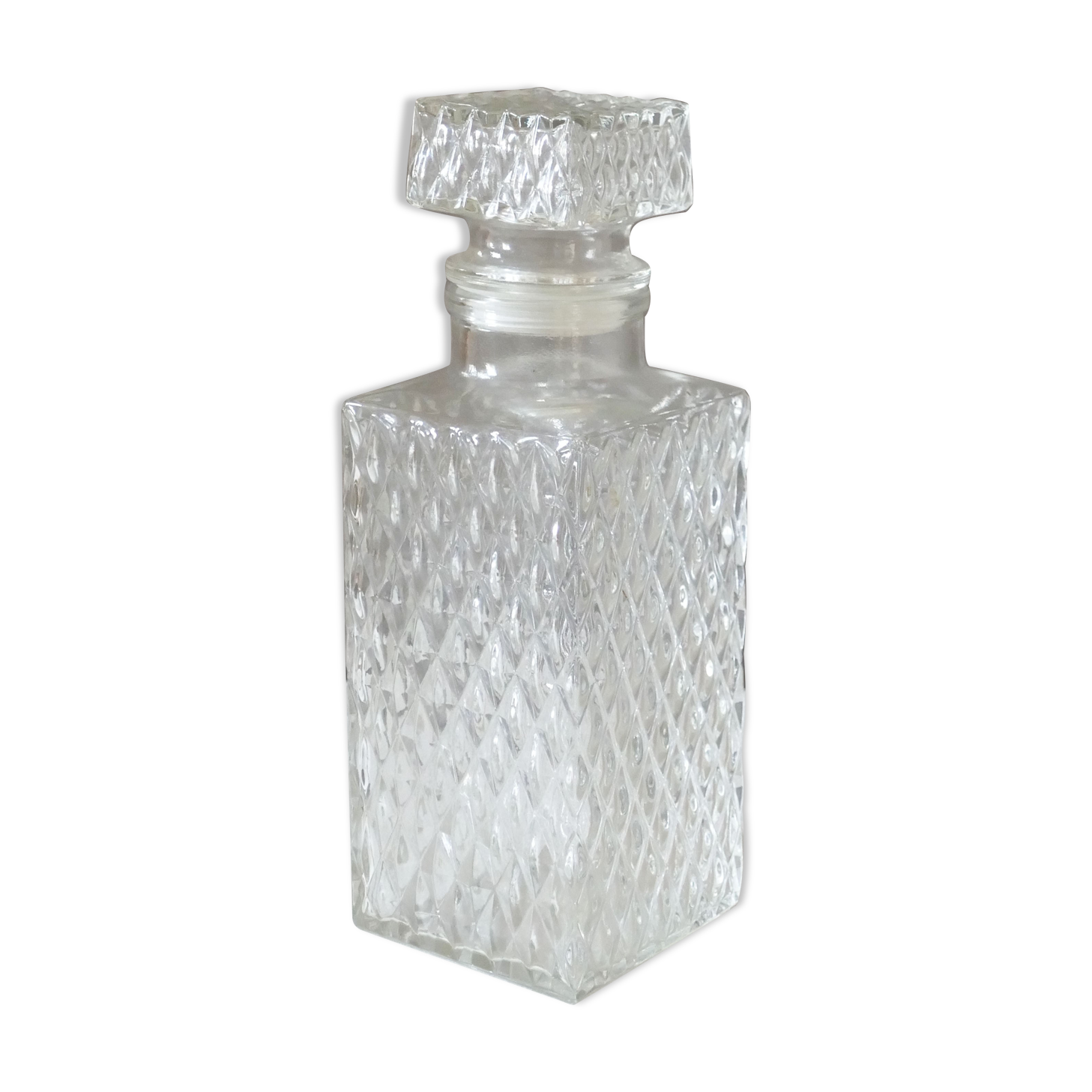Transparent vintage decanter in chiseled glass and its hermetic cap 70's years
