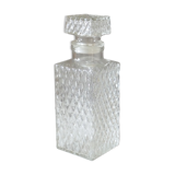 Transparent vintage decanter in chiseled glass and its hermetic cap 70's years