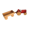 Old wooden red tractor with its trailer Haba