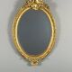 Oval gilded wooden mirror in Louis XV style, 19th century