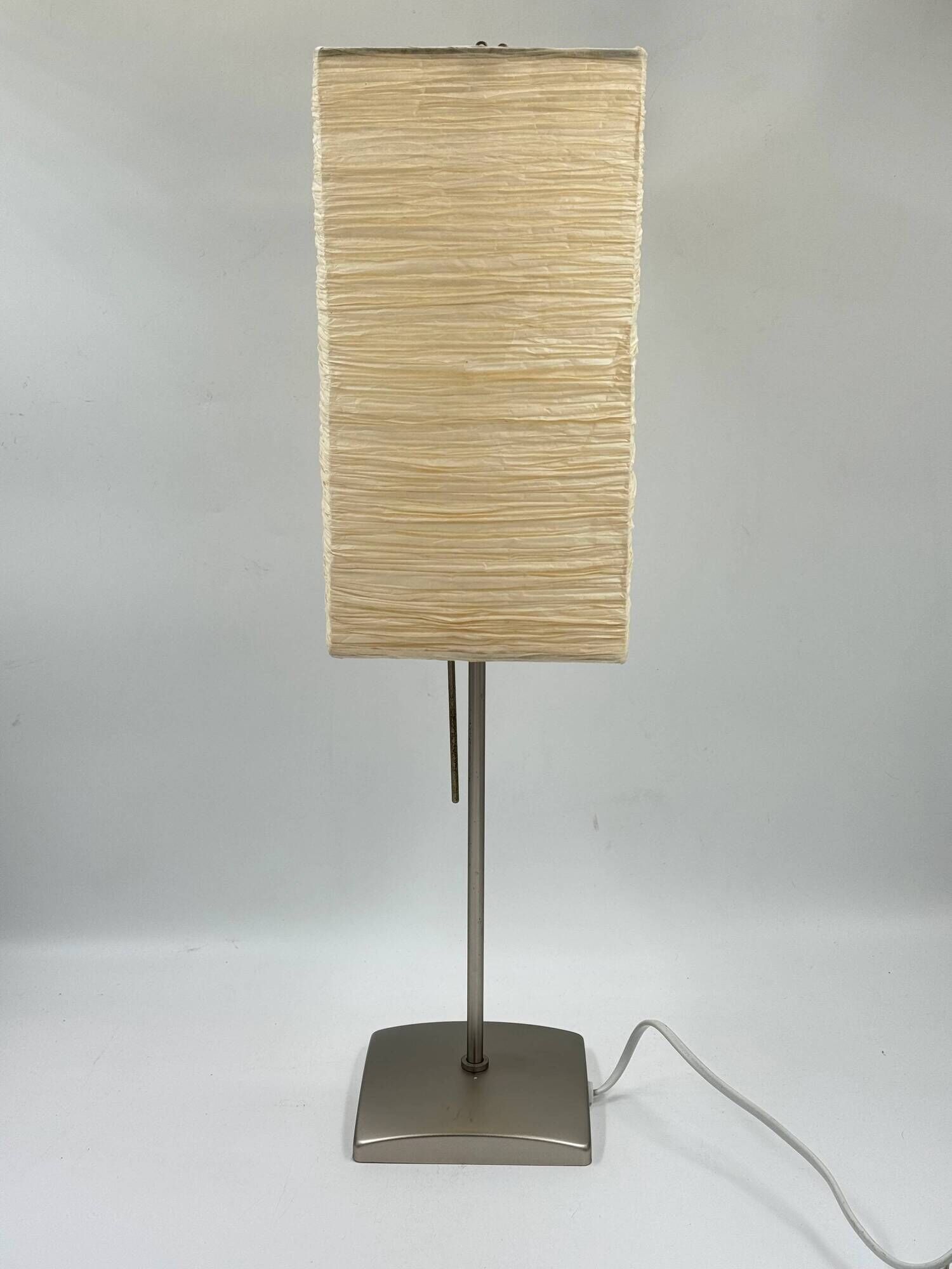 Vintage table lamp made of crumpled rice paper, with a matte metal base.