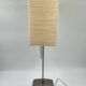 Vintage table lamp made of crumpled rice paper, with a matte metal base.