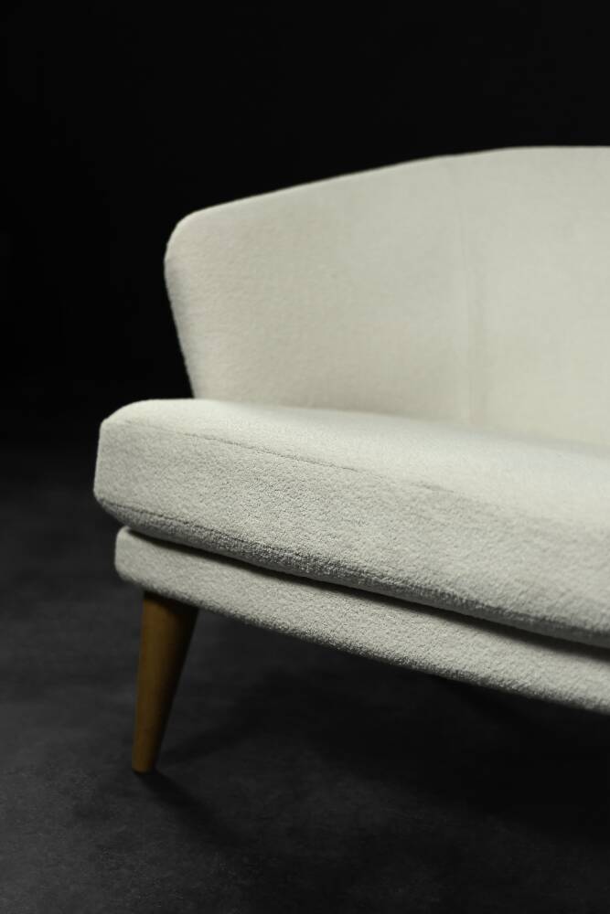 Low oak armchair with modern mid-century Scandinavian fabric and rounded backrest, 1960s.