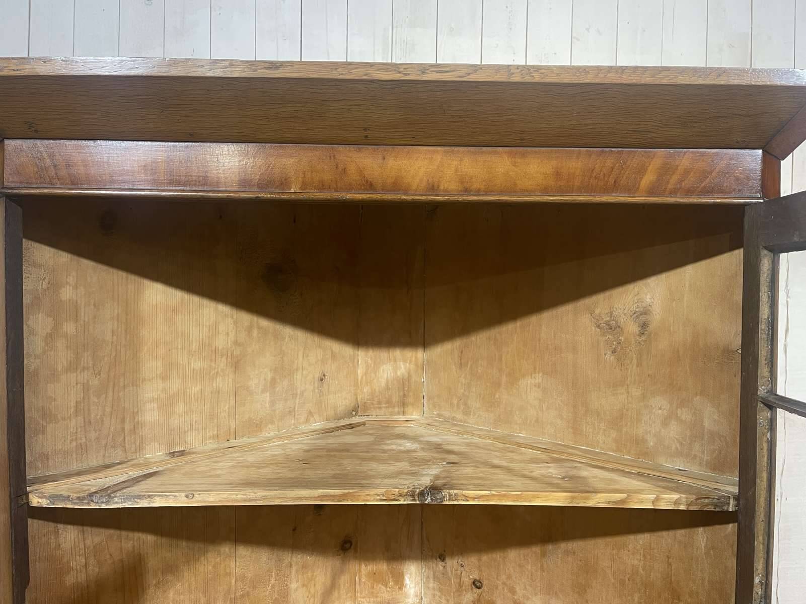19th-century English corner cabinet in oak, mahogany, and fir.