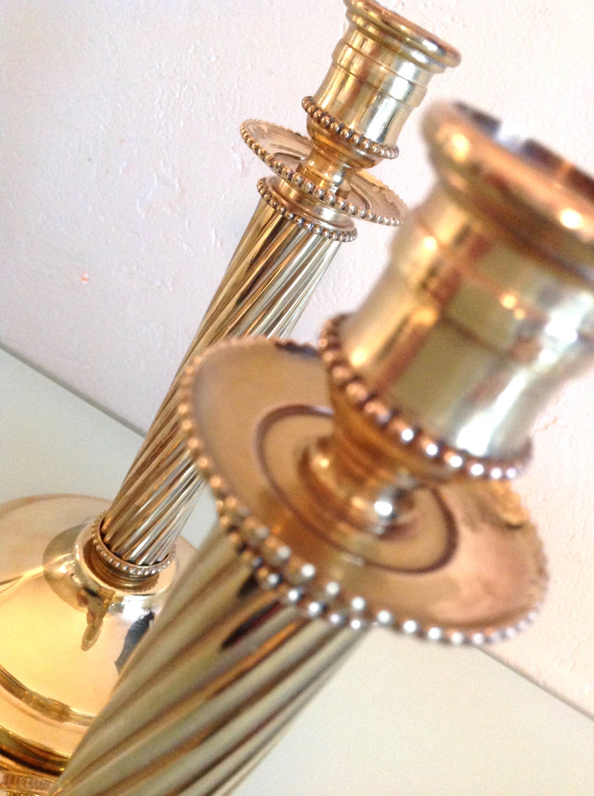 Pair of empire style brass candlesticks