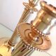 Pair of empire style brass candlesticks