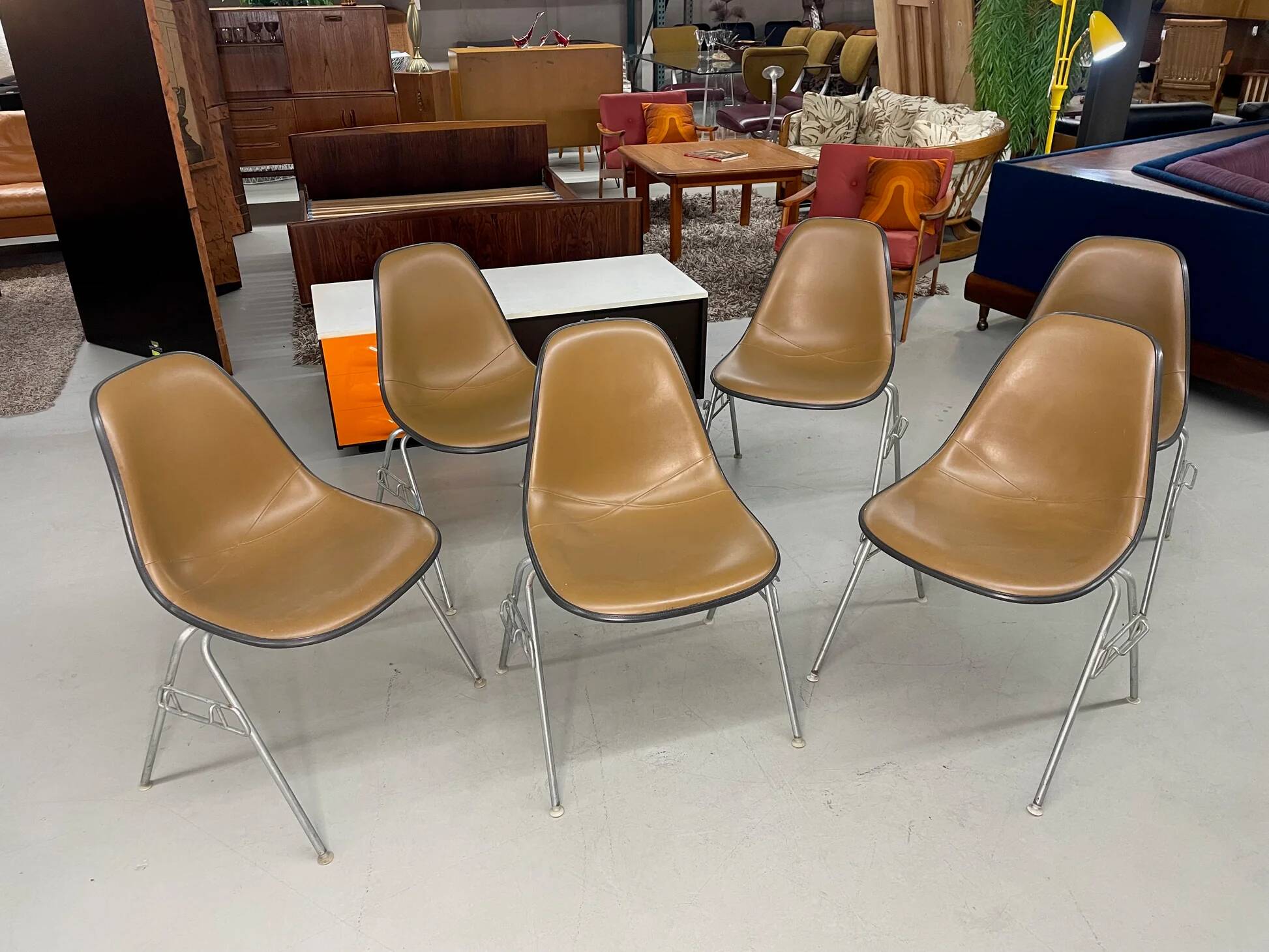 6 Herman Miller Eames stacking shell chairs with brown naugahyde pads