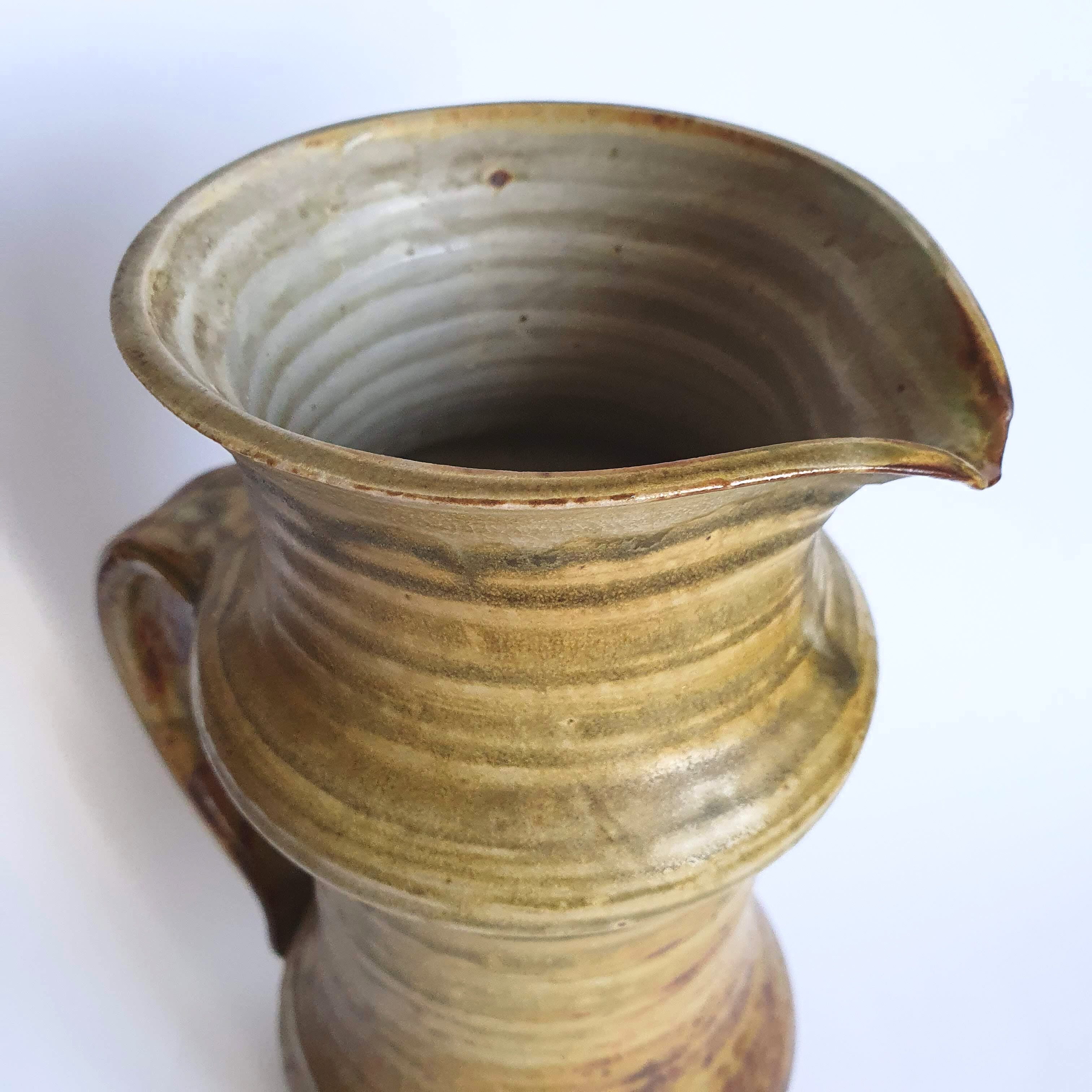 Enamelled sandstone pitcher signed