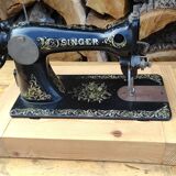 Old Singer sewing machine on pedestal