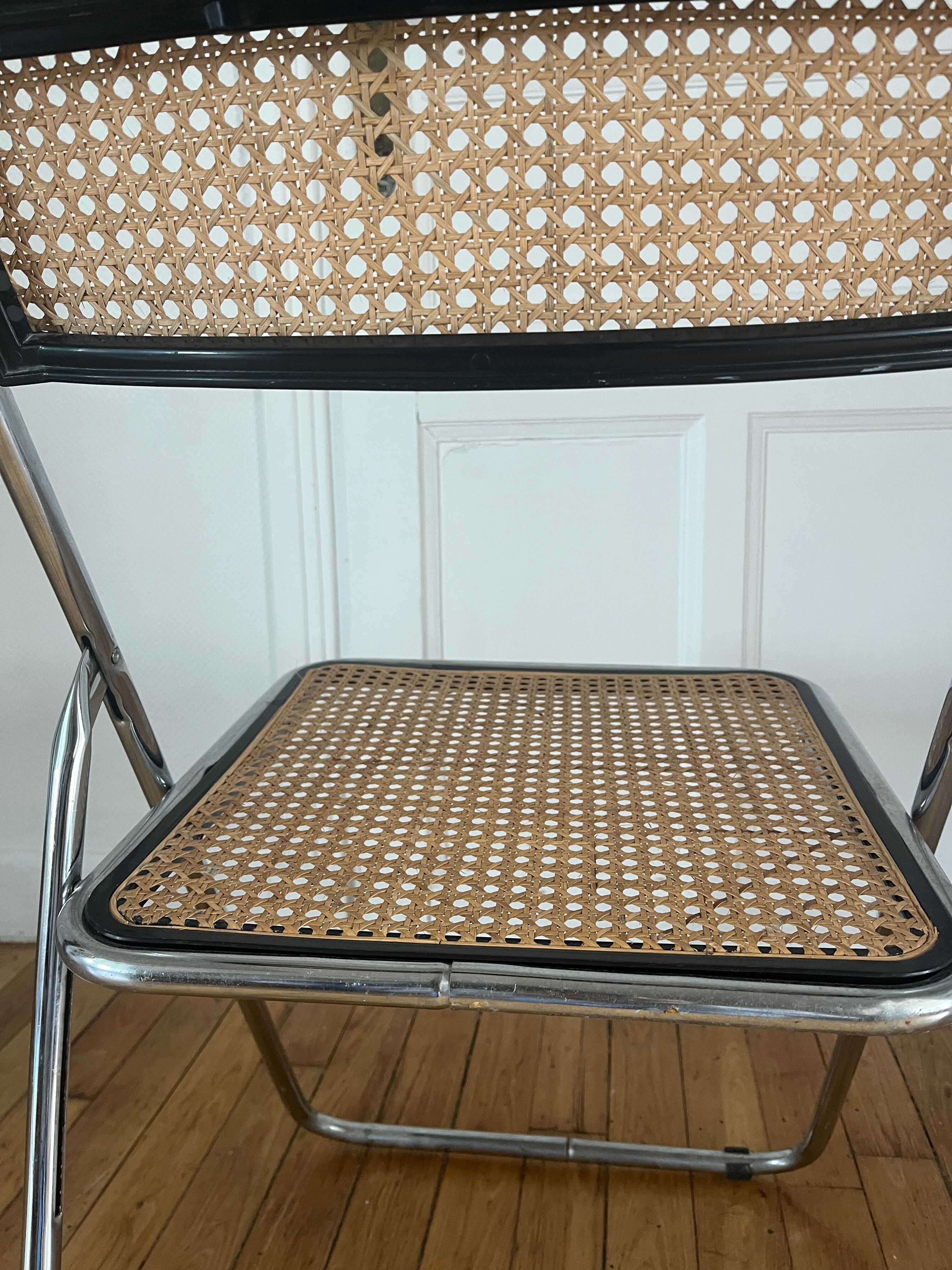 Vintage folding chair in metal and cane.