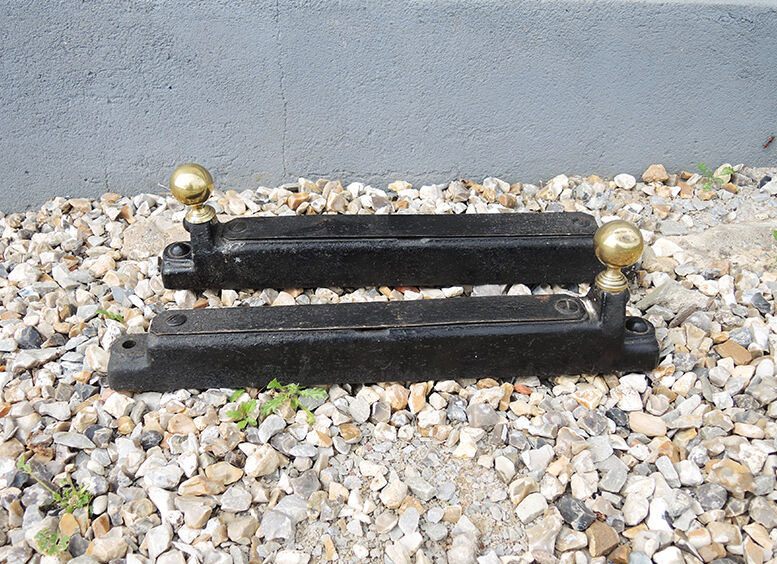 Old cast iron and xl brass andirons in neo classical style