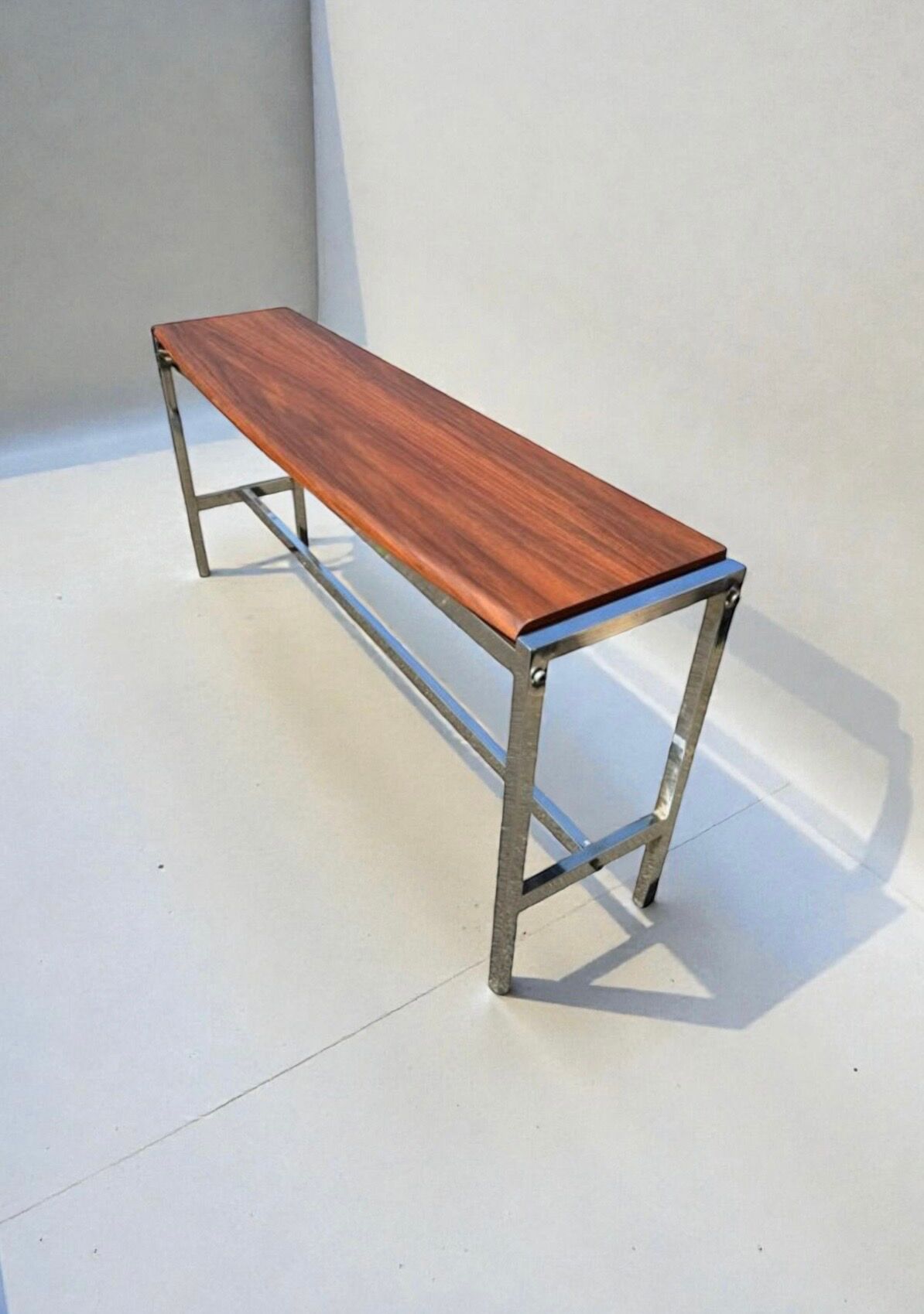 Curved base console in Scandinavian design – mahogany and chrome