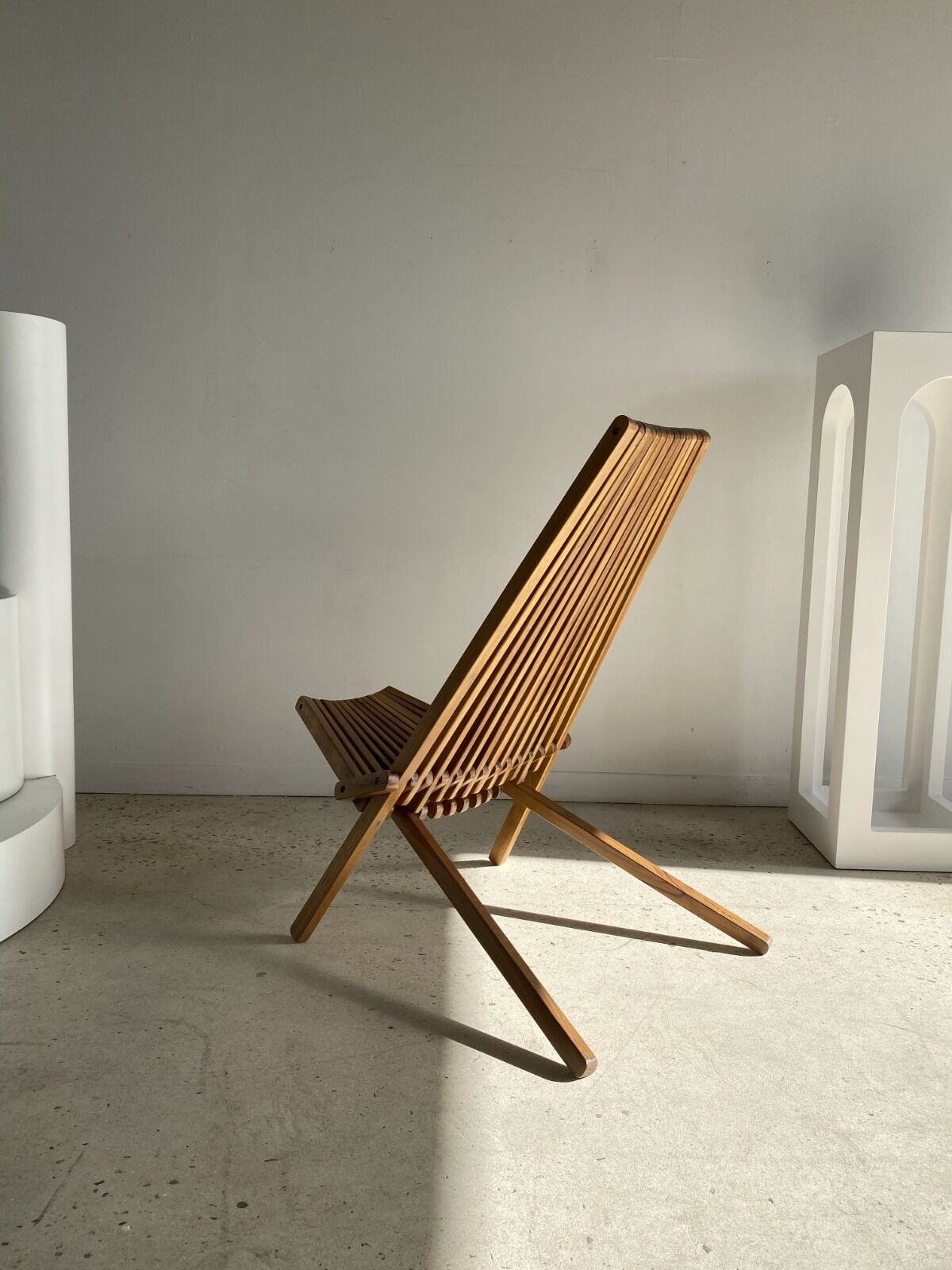 Foldable designer armchair in wooden slats