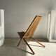 Foldable designer armchair in wooden slats