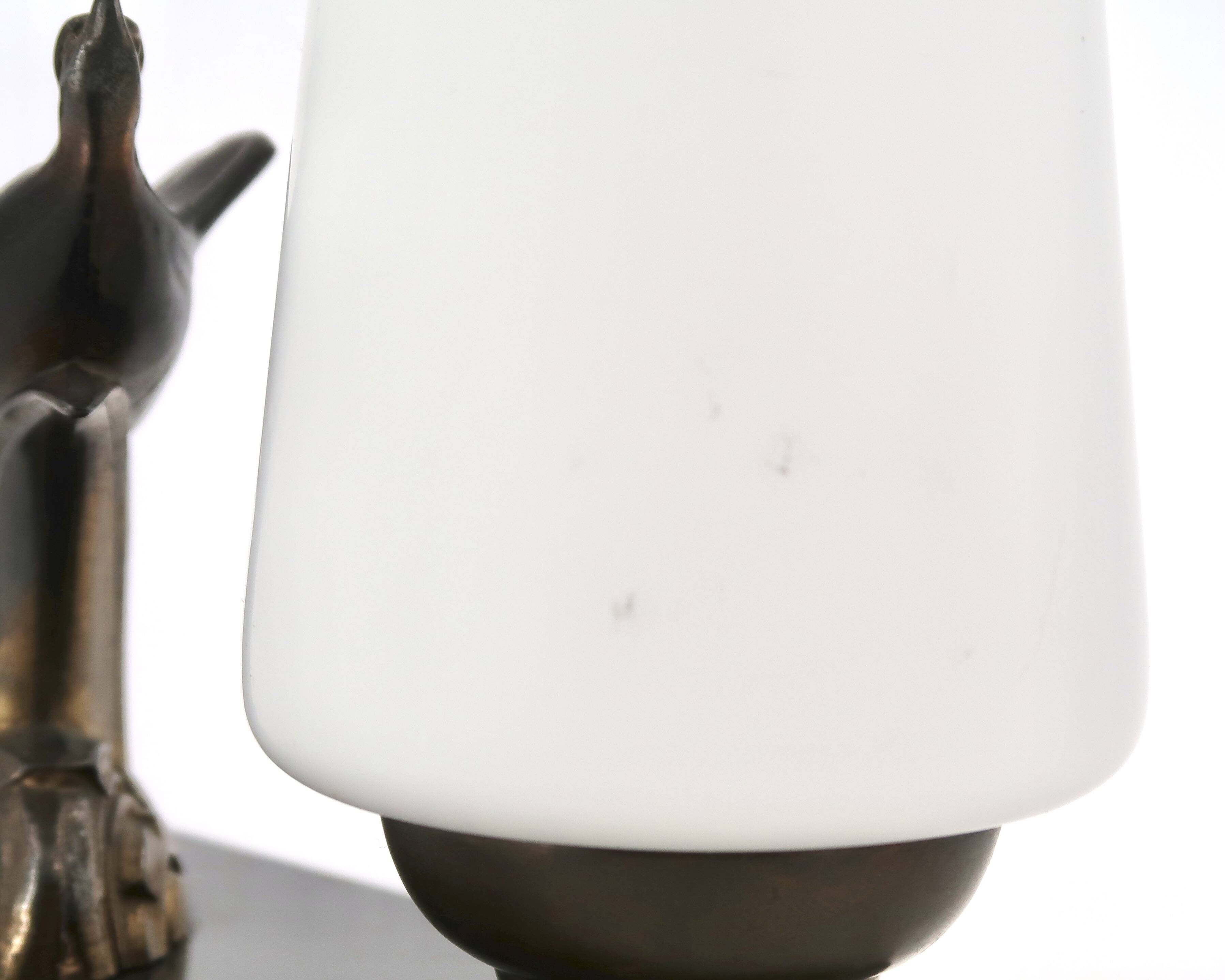 Art Deco lamp with swallow sculpture, marble base, opaque white globe.