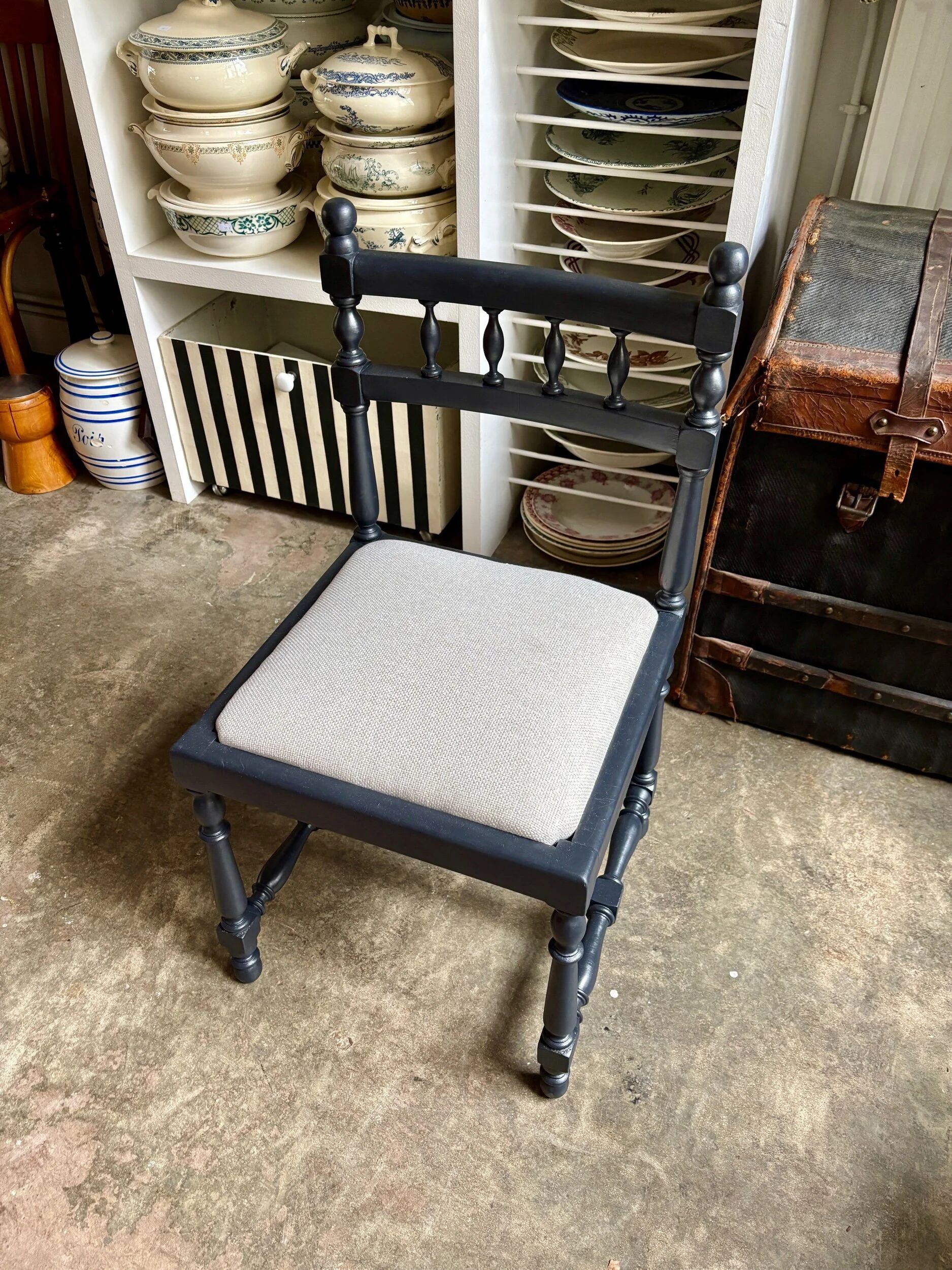 Black turned wooden chair and ivory cotton.