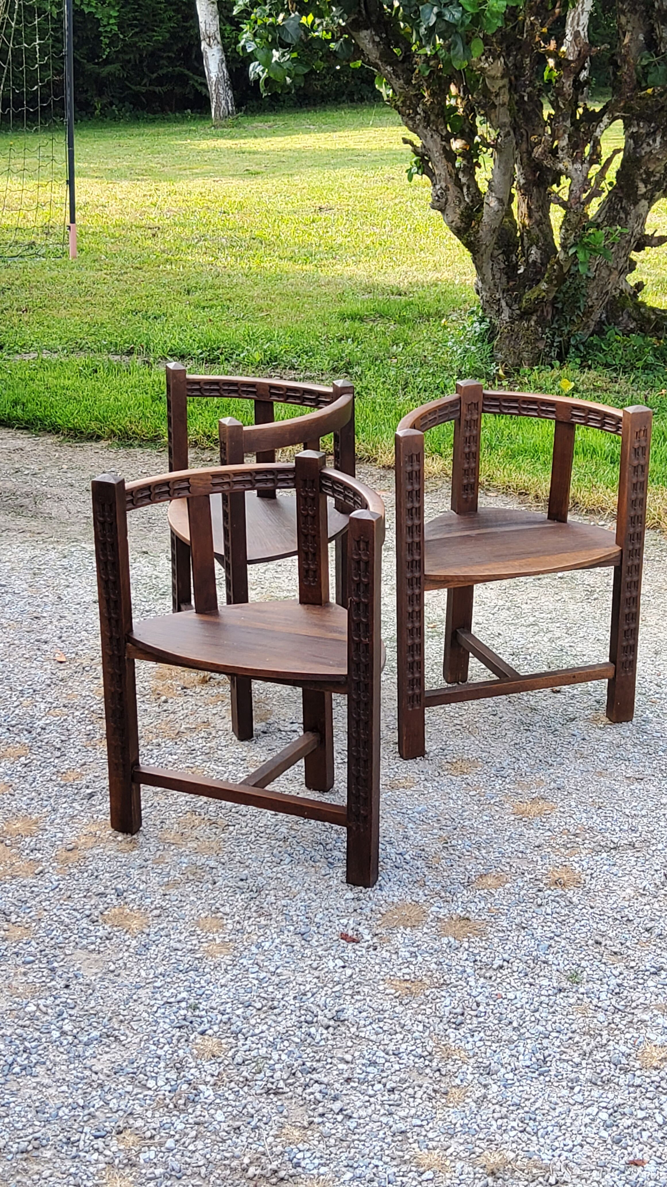 Set of three brutalist tripod armchairs in carved solid oak
