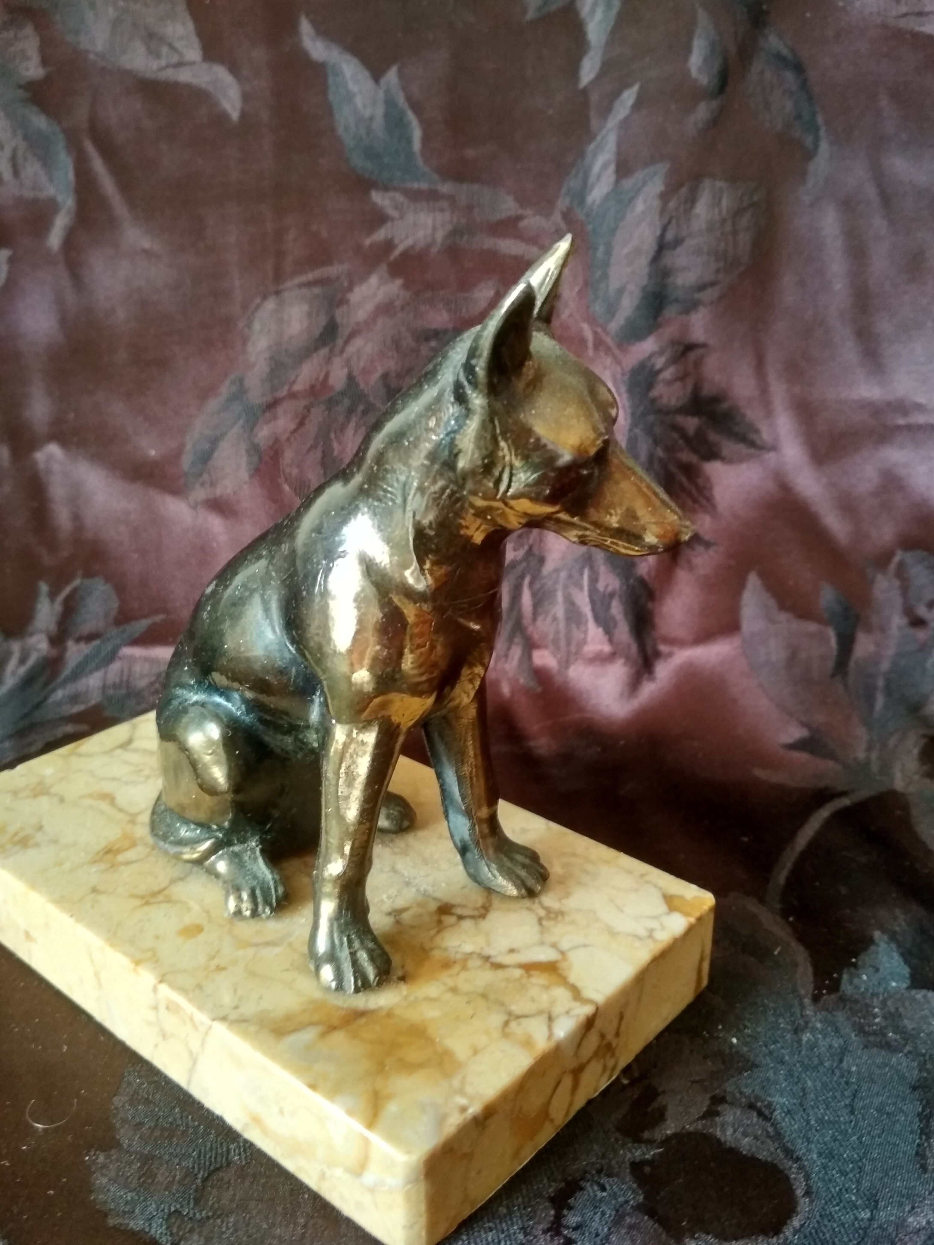 Greenhouse book dog sculpture regulates on marble slab