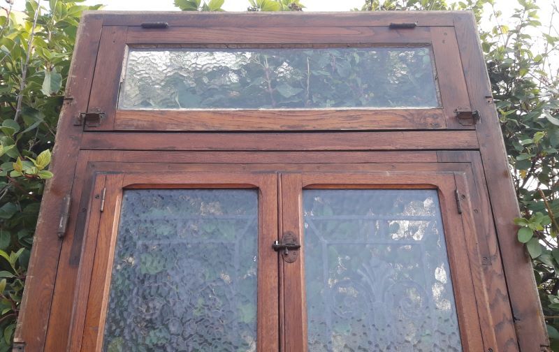 Oak entrance door and its frame and transom, wrought iron gates