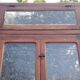 Oak entrance door and its frame and transom, wrought iron gates