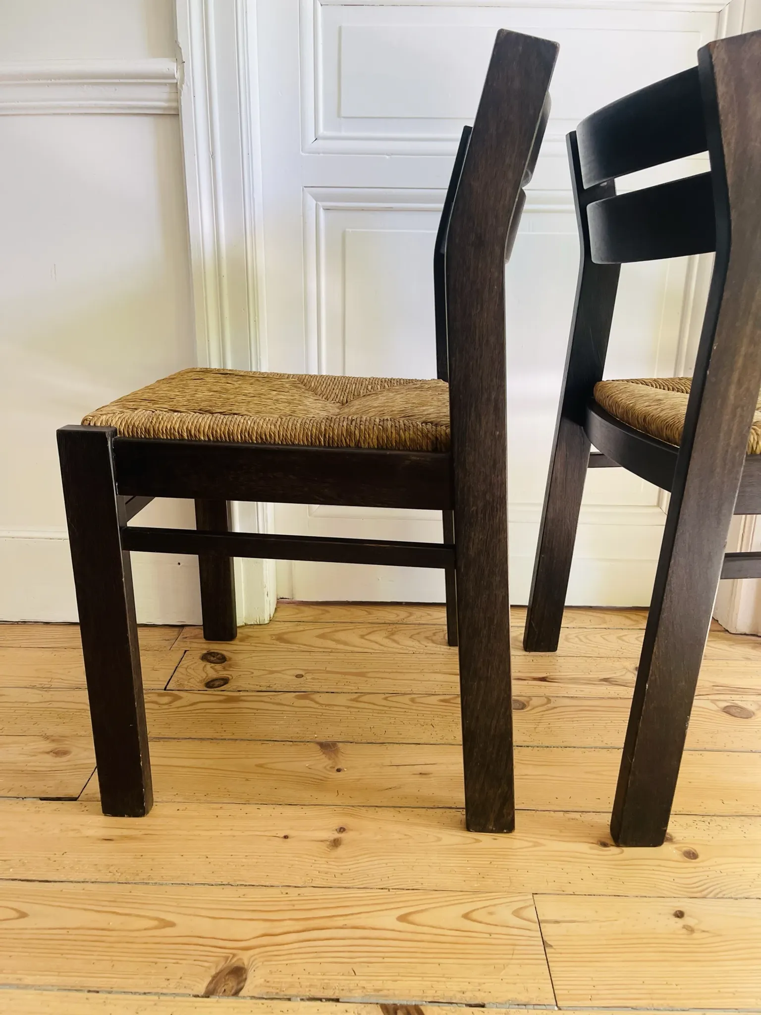 Pair of straw-seated wooden chairs in the regain style.