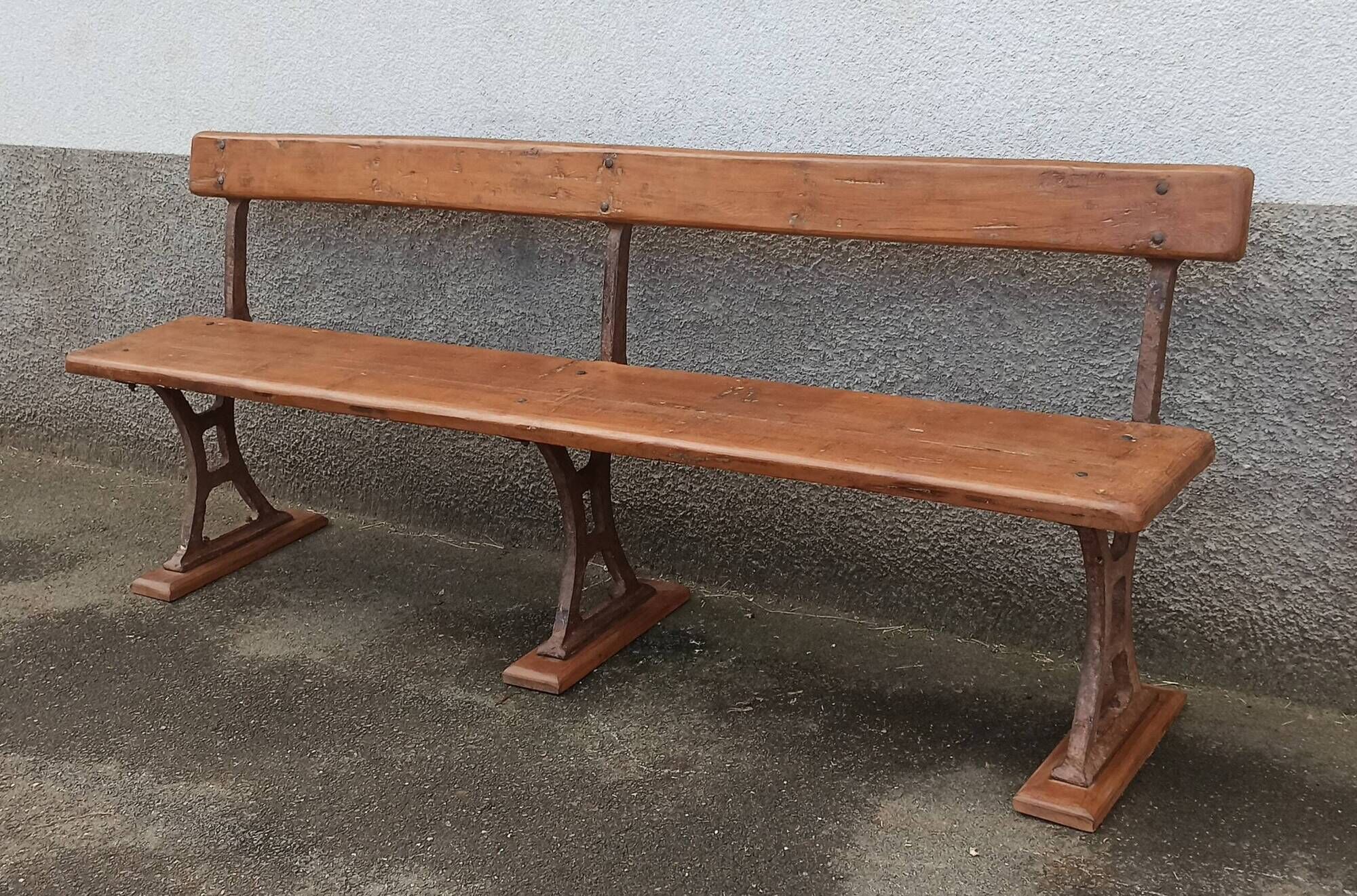 Old wooden bench with cast iron base