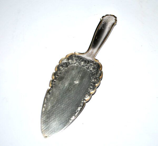 Vintage silver-plated pie server with rose decoration.