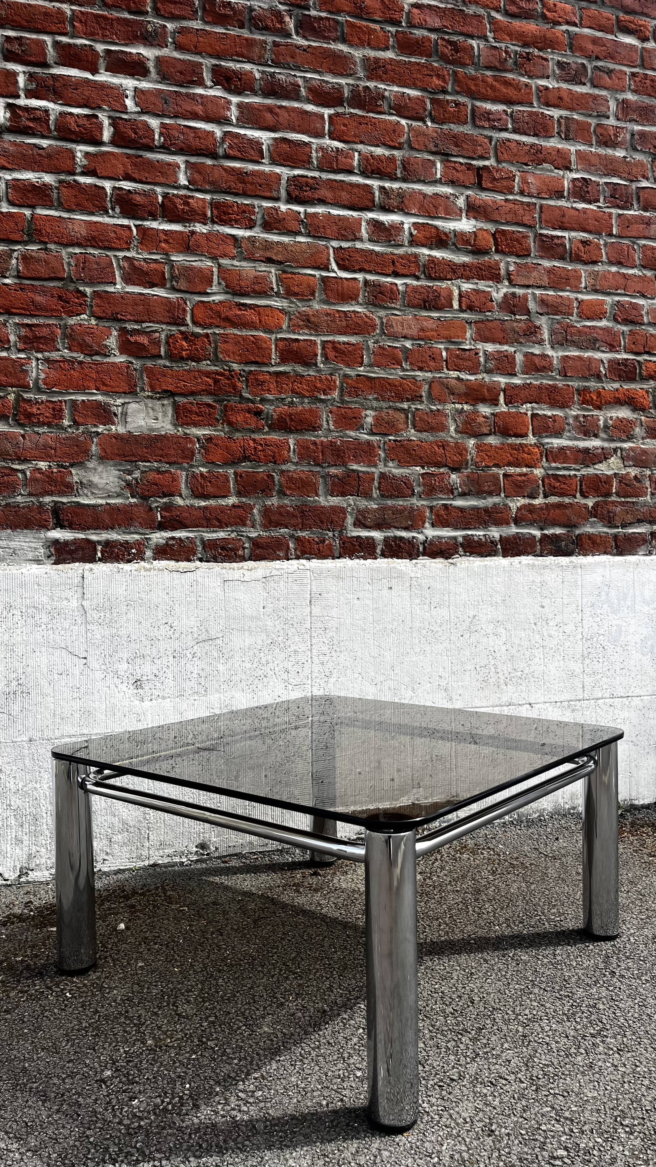 Vintage smoked glass coffee table with chrome structure.