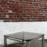 Vintage smoked glass coffee table with chrome structure.