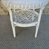 Round white rattan side table with storage underneath, circa 1970.