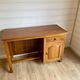Vintage wooden desk with 1 drawer and 1 door.