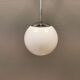 White hanging lamp with metal suspension, made with ball round opal glass shade.