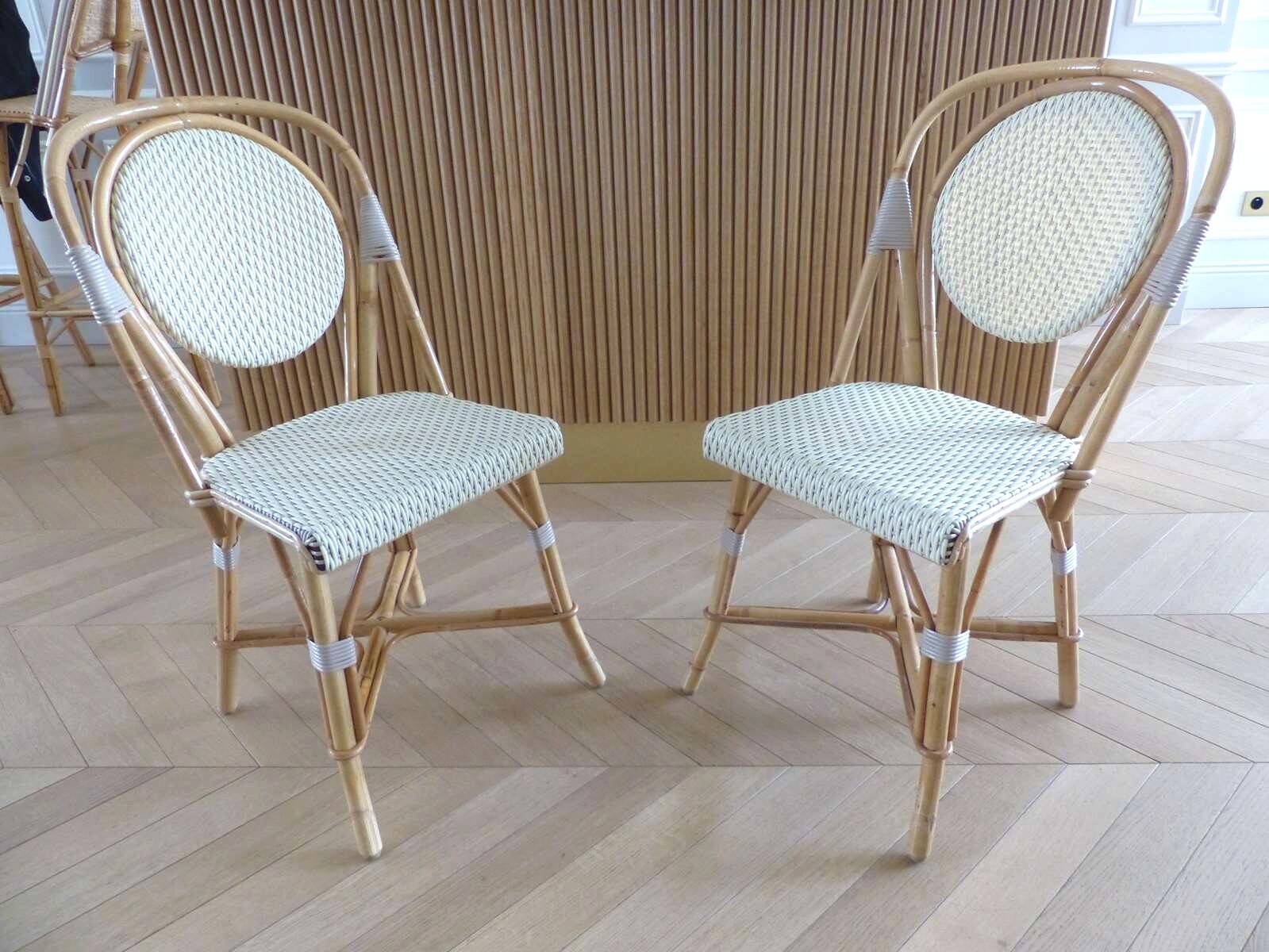 Pair of Parisian bistro chairs from Maison Louis Drucker in light Manila rattan.
