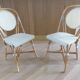 Pair of Parisian bistro chairs from Maison Louis Drucker in light Manila rattan.