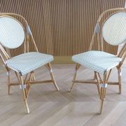 Pair of Parisian bistro chairs from Maison Louis Drucker in light Manila rattan.