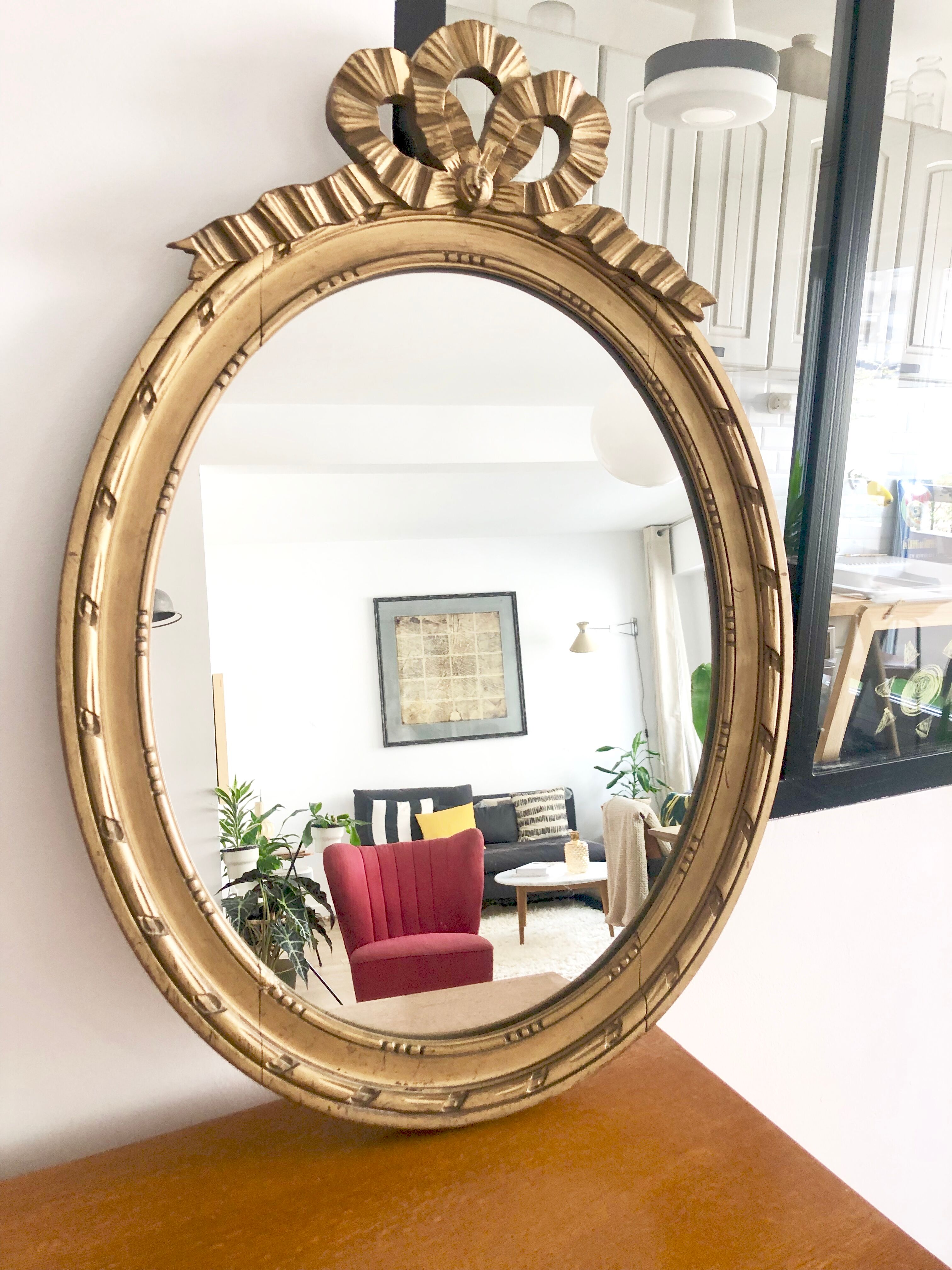 Old oval mirror with a pediment