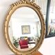 Old oval mirror with a pediment