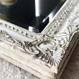 Beveled mirror in carved wood