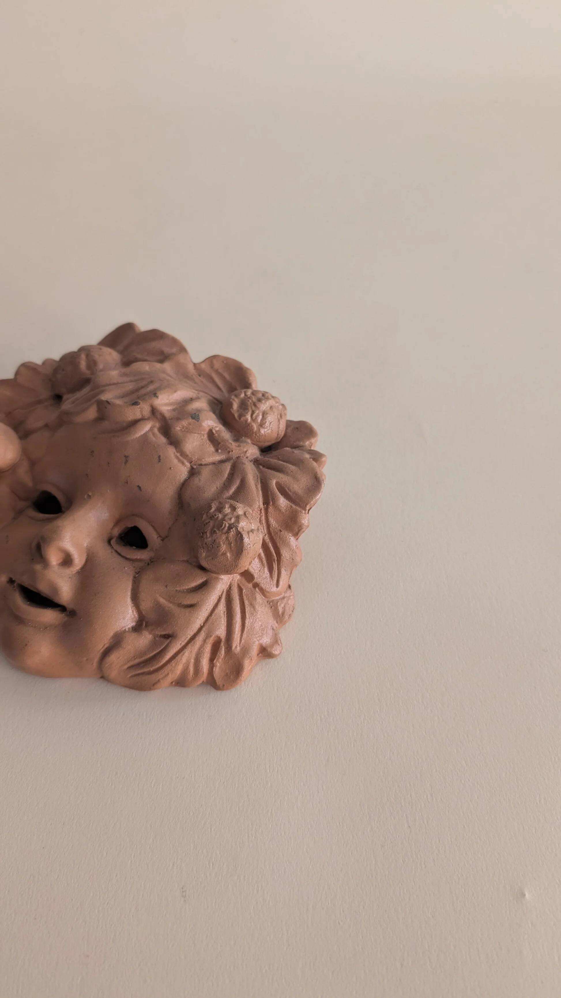 Vintage terracotta wall mask - flowery child's face